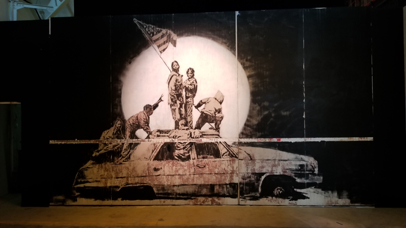 Flag Wall: A satirical take on Iwo Jima Memorial in Washington DC.