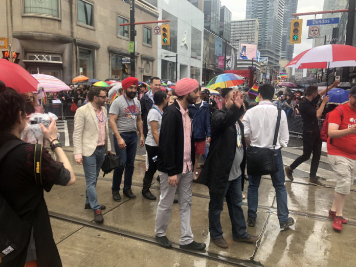 Navdeep Bains walks in Toronto Pride parade